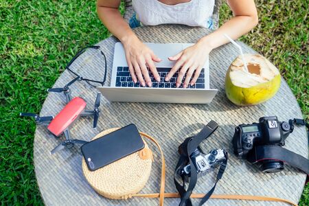Woman photographer takes a picture with professional camera from touristic trip to asia