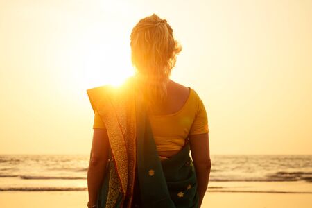 women in saree at tropics back site .の写真素材