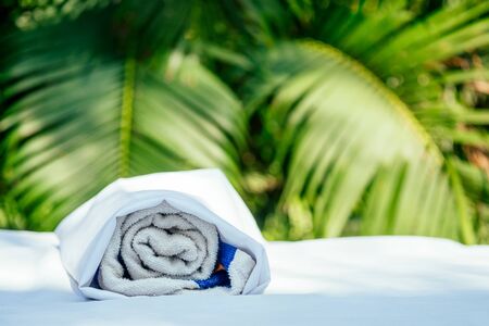 Spa towel on massaging table background in tropical beach outdoorsの写真素材