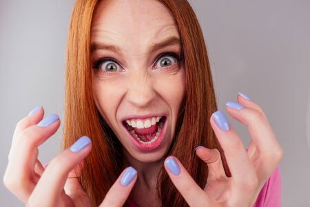 redhair ginger woman feeling angry and irritation studio background fish eye