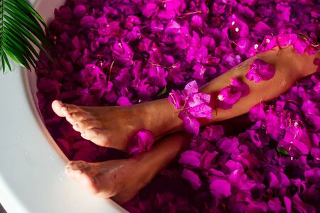 woman getting tropical bath in paradise spa resort