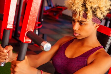 african american woman pull-up athletic iron indoors
