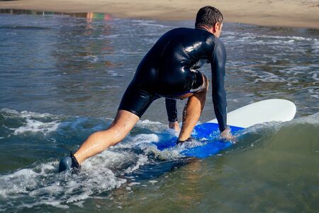surf instructor showing how riding on big waves in Goa India.の写真素材