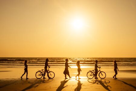six friends meeting on the beach in Goa India and having time together .