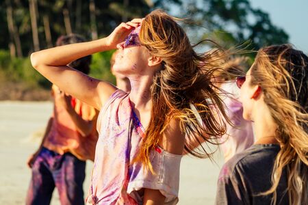 multinational multicultural mixed race friends in holi dust on beach in Goaの写真素材