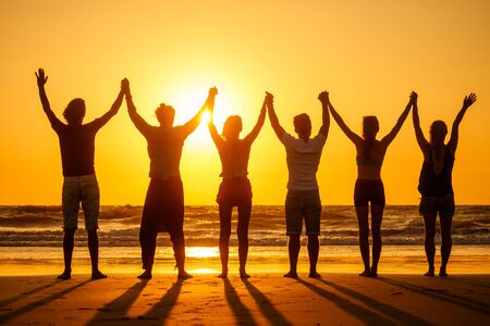 six health people in stand hatha position with hand up raced and breath full chest in Goa India...