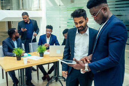 top view of team work high five a group of successful afro americans, europeans ,arabic and korean businessman and businesswoman workingの写真素材