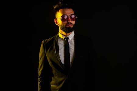 indian young handsome black hair man in stylish business suit in studio isolate white backgroundの写真素材