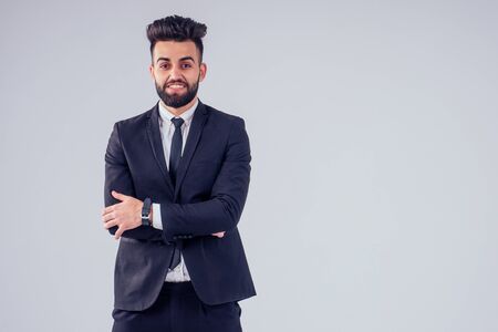 young handsome black hair man in stylish business suit in studio isolate white backgroundの写真素材
