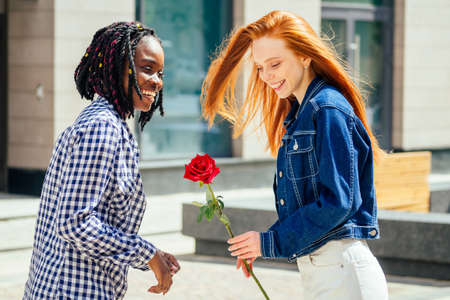caucasian redhaired ginger woman ask her brazilian girlfriend to be her wifeの写真素材