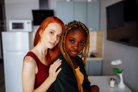 Two young lesbian girlfriends having fun at houseの写真素材