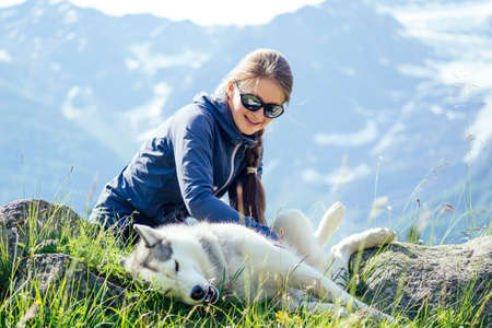 Dog with a woman walking mountains outdoors