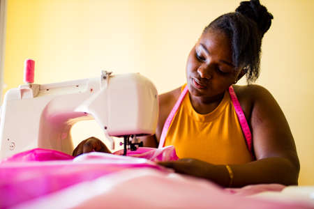 african american woman tailor creates a collection of outfitsの写真素材