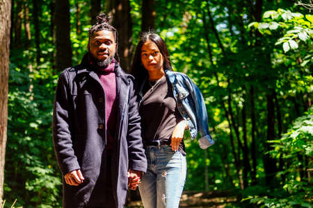 african american man with mixed race asian woman walking in the park
