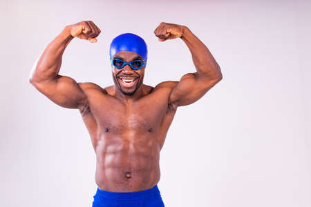 african american man trainer has wet muscular body, being in good mood after swimming and divingの写真素材