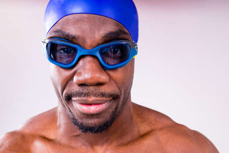 afro latin mixed race man swimmer getting ready to start swimming isolated on white background in...