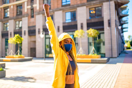 latin brazilian woman in yellow hoody with yellow pigtails dreadlocks in the street took to the...