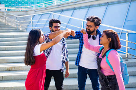 indian students keeping distance and do home work outdoors