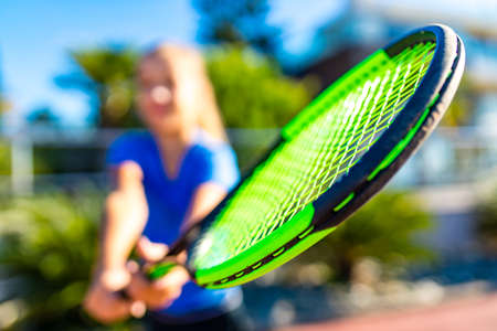 little girk playing tennis in tropical place outdoors