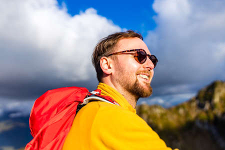 smiling man with braces on mountainの写真素材