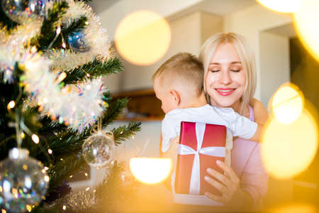 mother and children with gift at homeの写真素材
