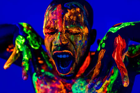 afro american man with UV body art posing in studioの写真素材