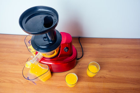raw food diet concept oranges and juicemachine in white background