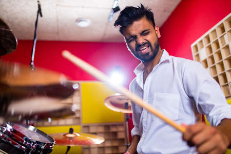 italian artist musician playing drumms during online concert at studioの写真素材