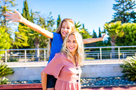 blonde mom and her cute child in summer beach seaside in tropics
