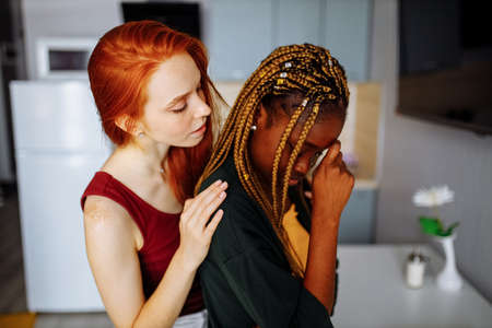 mixed race women at their house togetherの写真素材