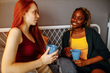 mixed race women at their house togetherの写真素材