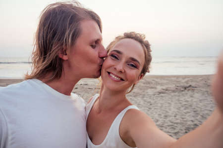 happy couple in love having a rest together on the beach near ocean or sea.concept of travel...
