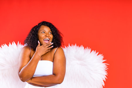 spain cheerful angel with wings on red background studioの写真素材