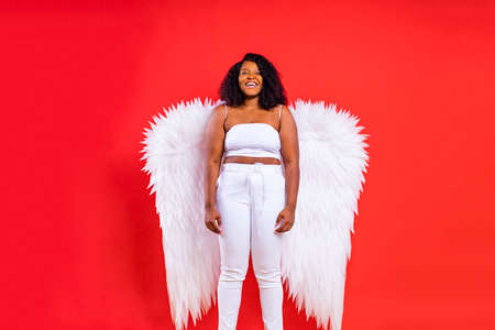spain cheerful angel with wings on red background studioの写真素材
