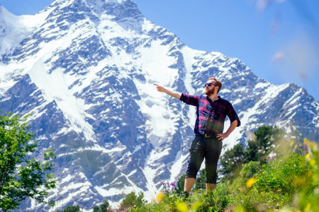 man in blue jacket with rain in mountainsの写真素材