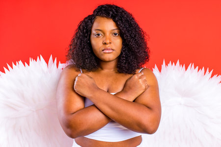 spain cheerful angel with wings on red background studio.の写真素材