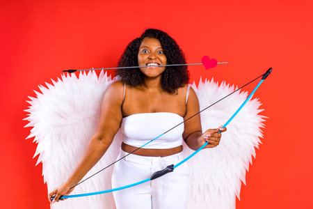 latin hispanic woman hold bow and arrow Valentines Day The 14th of Februaryの写真素材