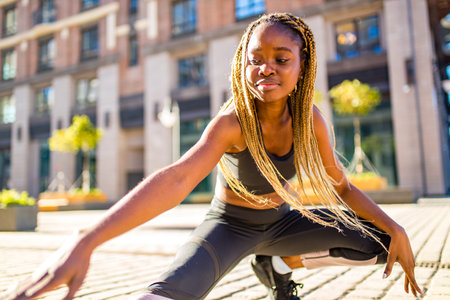 latin hispanic girl with long yellow dreadlocks pigtails working out outdoor in ste streets in sity down townの写真素材
