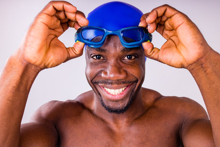 afro latin mixed race man swimmer getting ready to start swimming isolated on white background in...
