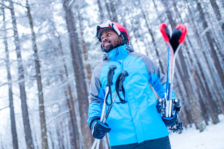 latin american young skier man forest winter day in New Year holidays Christmas