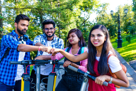 modern indian friends ride on scooter in park in Indiaの写真素材