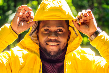african american man in yellow jacket with a hood and dreadlocks pigtails