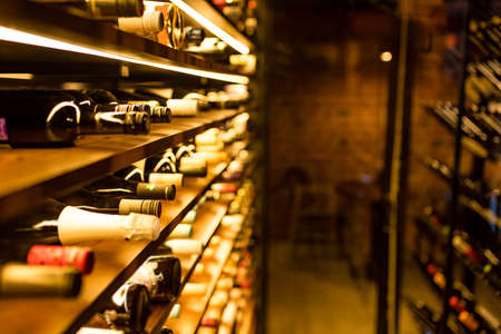 bottles of old beautiful wine in a warehouse in a storeの写真素材