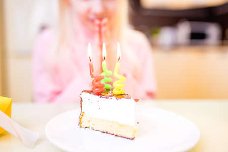 Little girl celebrate Happy Birthday Party in kitchen at homeの写真素材