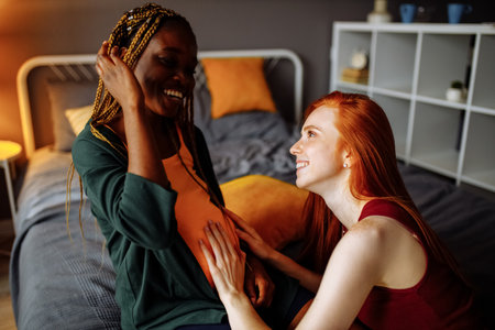 mixed race couple awaiting a baby in roomの写真素材
