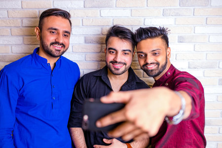 friends from india talking in living room and have funの写真素材