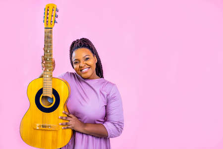 authentic african american performer player positive mood training in pink studio background