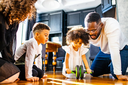 afro american mixed-raced family looking at camera in cozy summer day light in living roomの写真素材