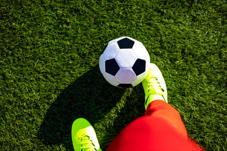 spanish man playing a hoppy football outdoors in sunny park