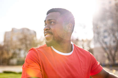 hispanic man in red cotton t-shirt feeling peace confident outdoors summer in downtown cape town